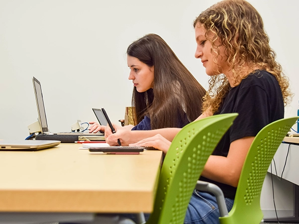 Two students researching together in a classroom.