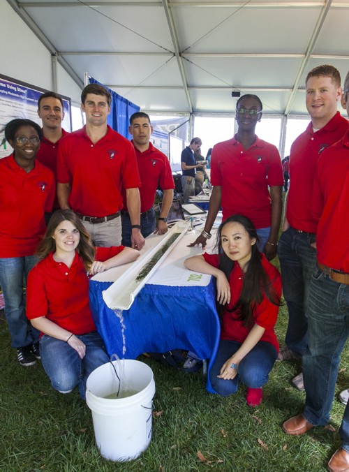 a group of students standing around a table