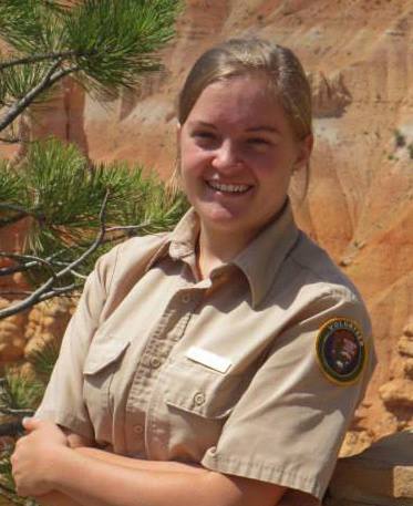 a female student standing with her arms crossed