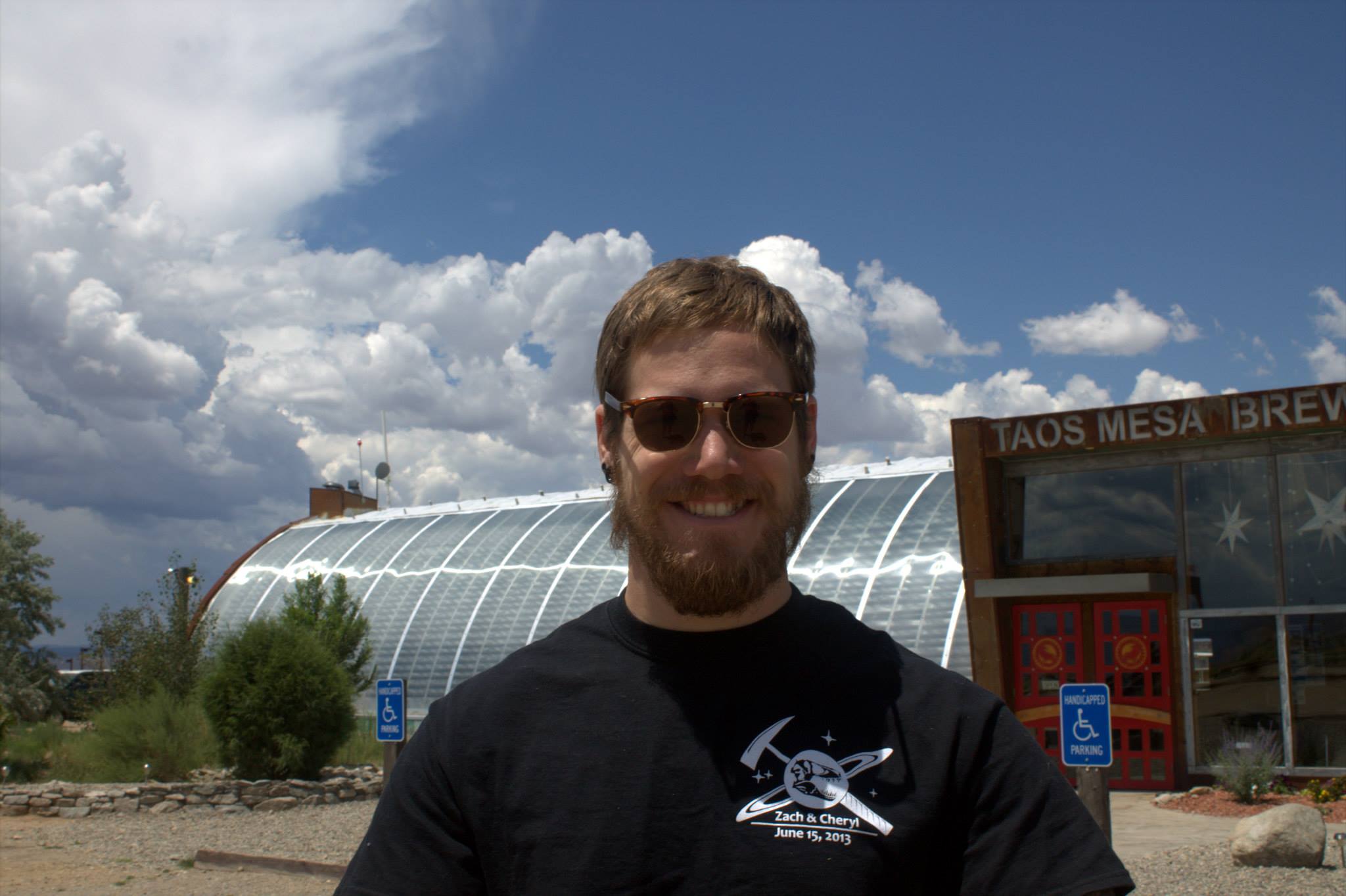 a male student standing in front of a building