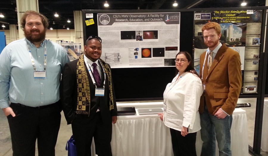 CSU students and a professor standing in front of a poster