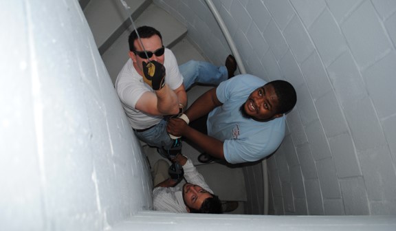Several students lookuping up from a stairwell