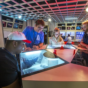 several students observing another student performing a science experiment