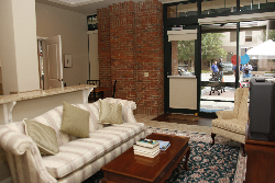 a living room scene with a couch and a large window in the background