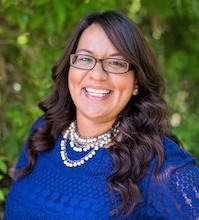 Monica Benitez a female with long brown hair wearing glasses