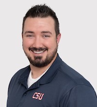 Derrick Warnock a male with brown hair, facial hair, smiling