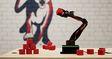 a robotic arm picking up text-sm red cubes