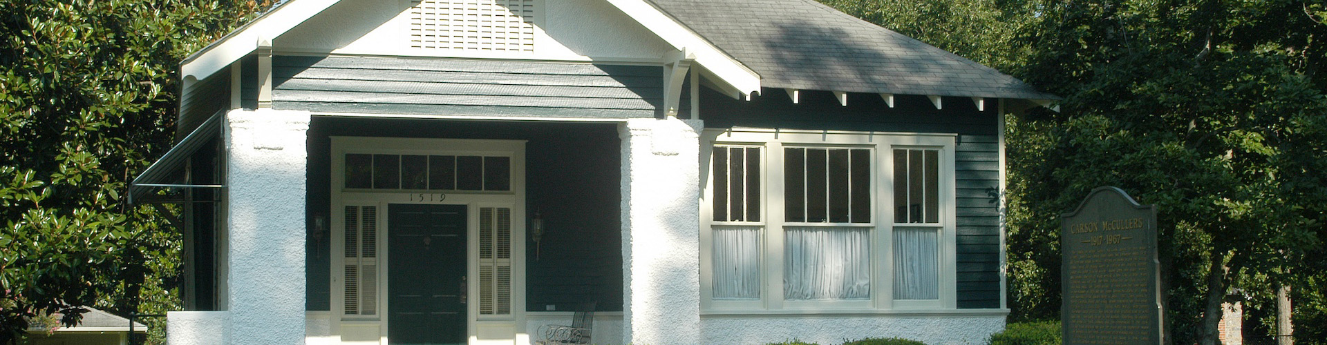 the front side the Carson McCullers house with green door and green and white walls