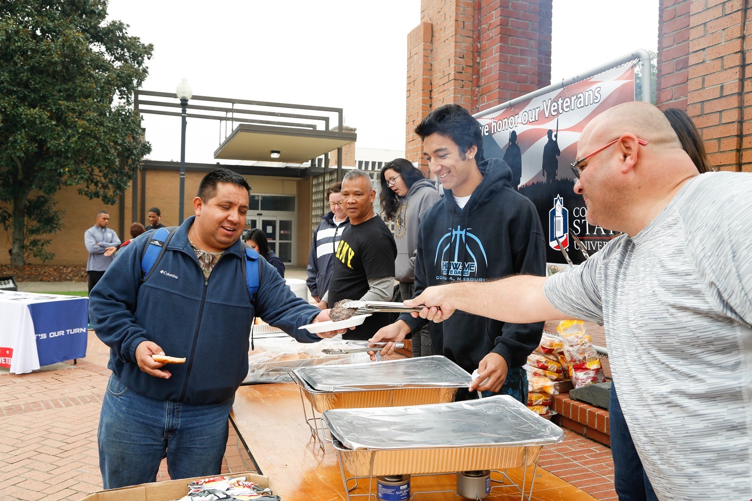 students serving an outdoor picnic/luncheon