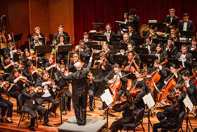 Several students performing with instruments