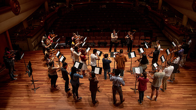Group of students playing viola on a stage