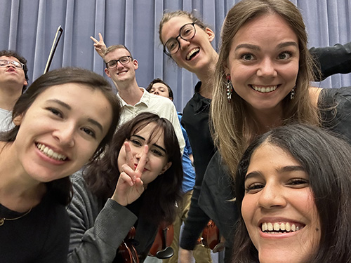 several students close up to the camera smiling