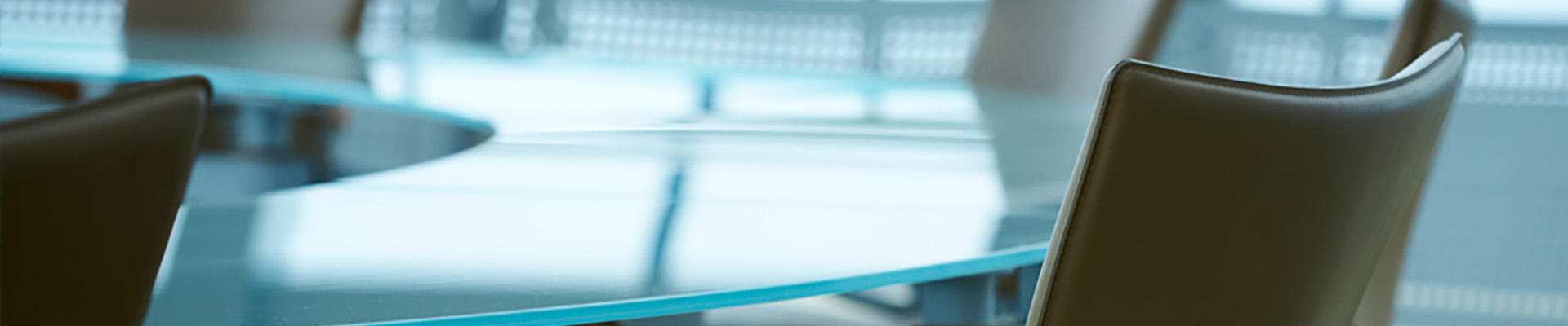 a brown chair in front of a glass table
