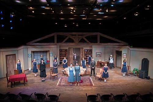a large group of people standing on a stage set