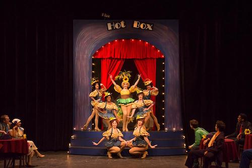 several people standing together in a group posing on a stage