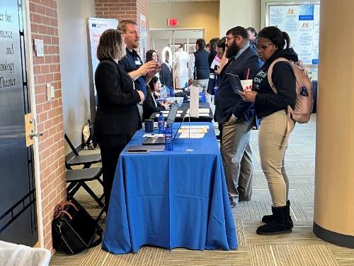 Faculty and Students in the Synovus Building Lobby