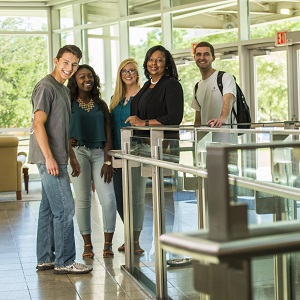 several people standing in a group posing for a photo