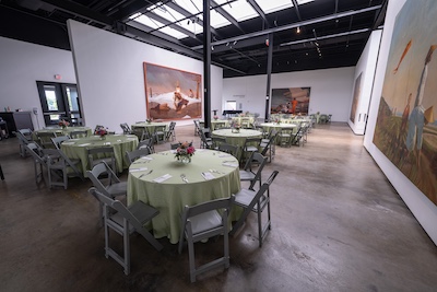 covered circular tables with artworks on the wall