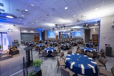 covered circular tables with floral centerpieces