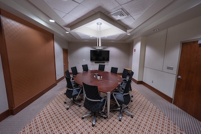 10-person conference desk, tv on the wall
