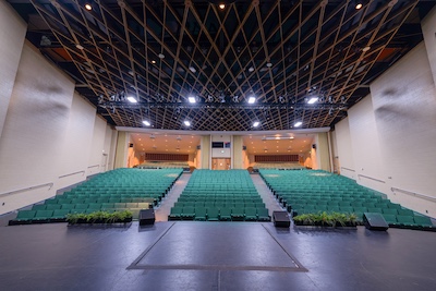 dark auditorium, people on stage